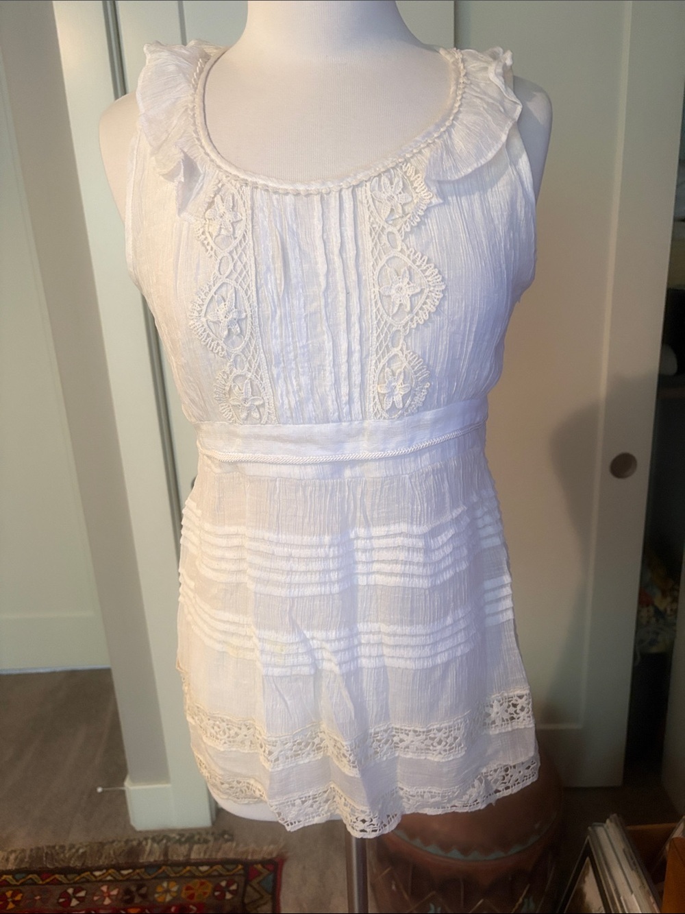 Ivory Sleeveless Crochet Trim Peasant Top with elastic empire waist.